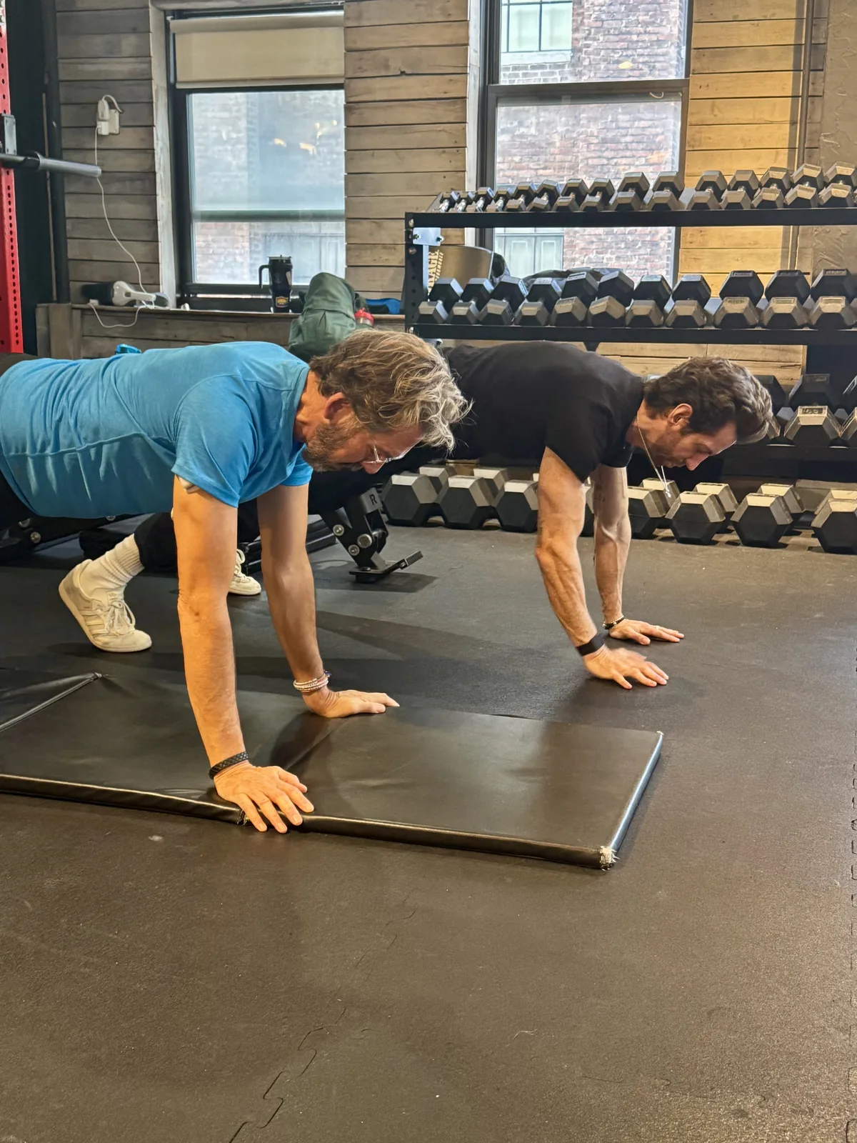 Personal trainer for seniors NYC — BUF Over 50 coach training alongside an older client at the Midtown Manhattan studio