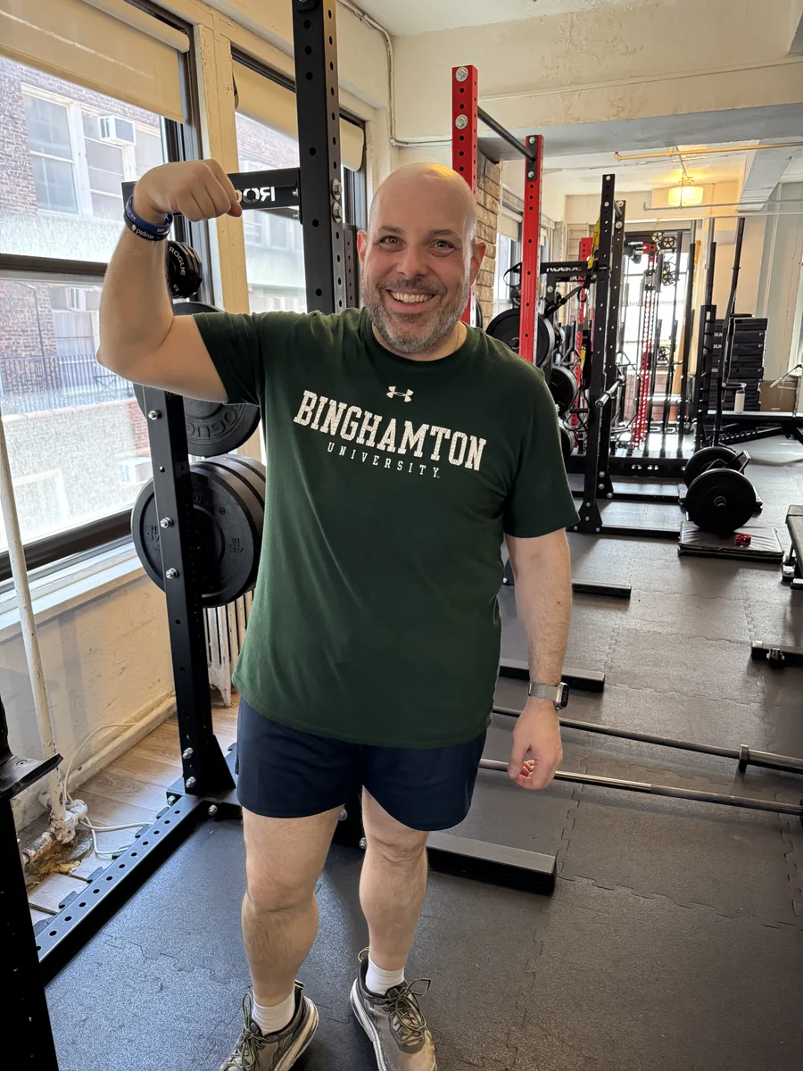 Strength training for men over 50 — older man showing arm strength after a session at the BUF Over 50 studio in Midtown Manhattan